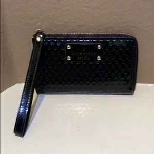 Kate Spade black shiny wristlet with gold accents
